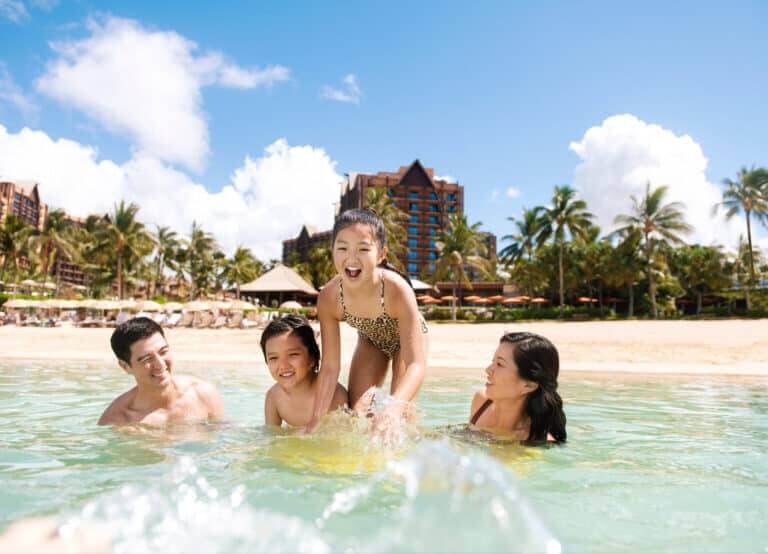 How to become a travel agent from home - family swimming at Disney Aulani resort in Hawaii