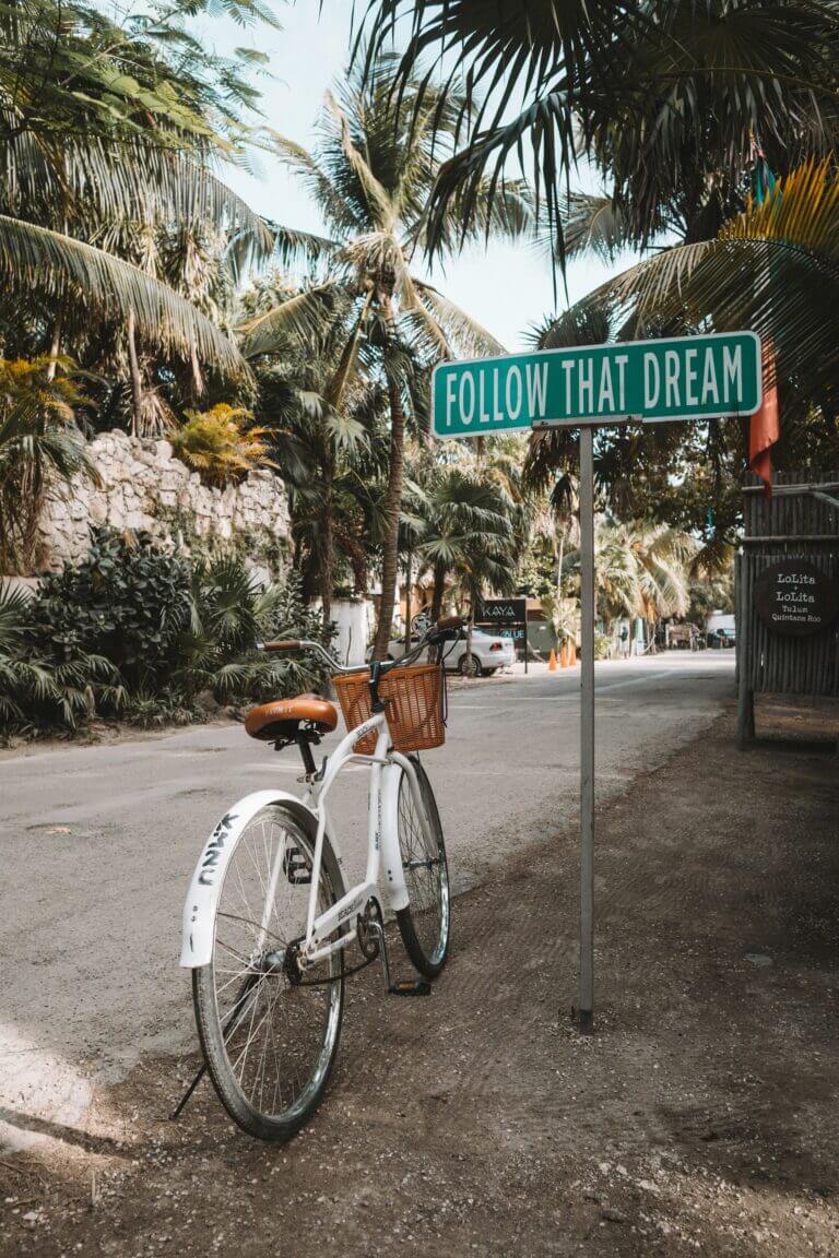 Expedia travel agent - bike in front of sign