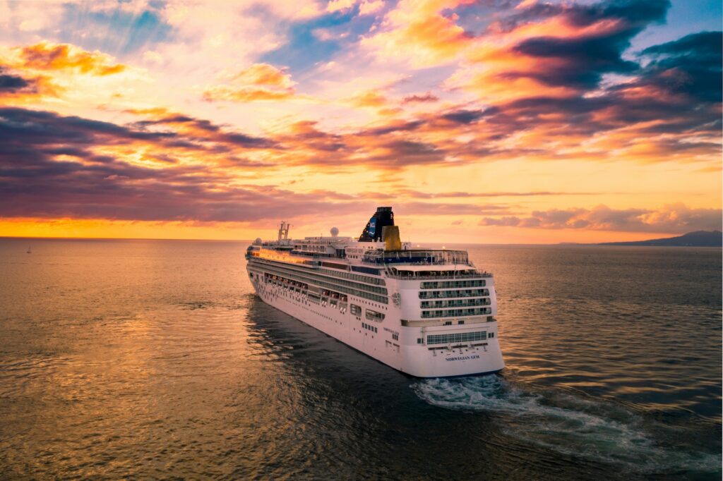 How to become a cruise travel agent from home - cruise ship on the ocean at sunset