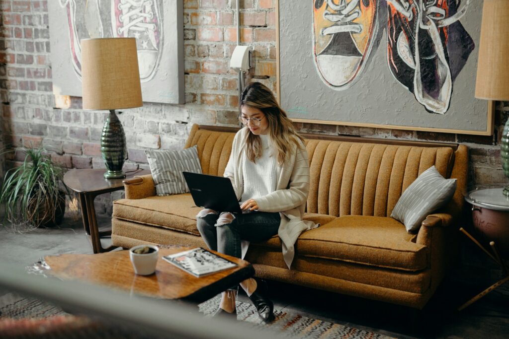 Best travel agency to work for - woman sitting down using a laptop