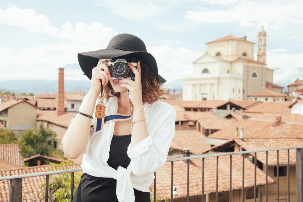 Best travel agency to work for - woman holding a camera